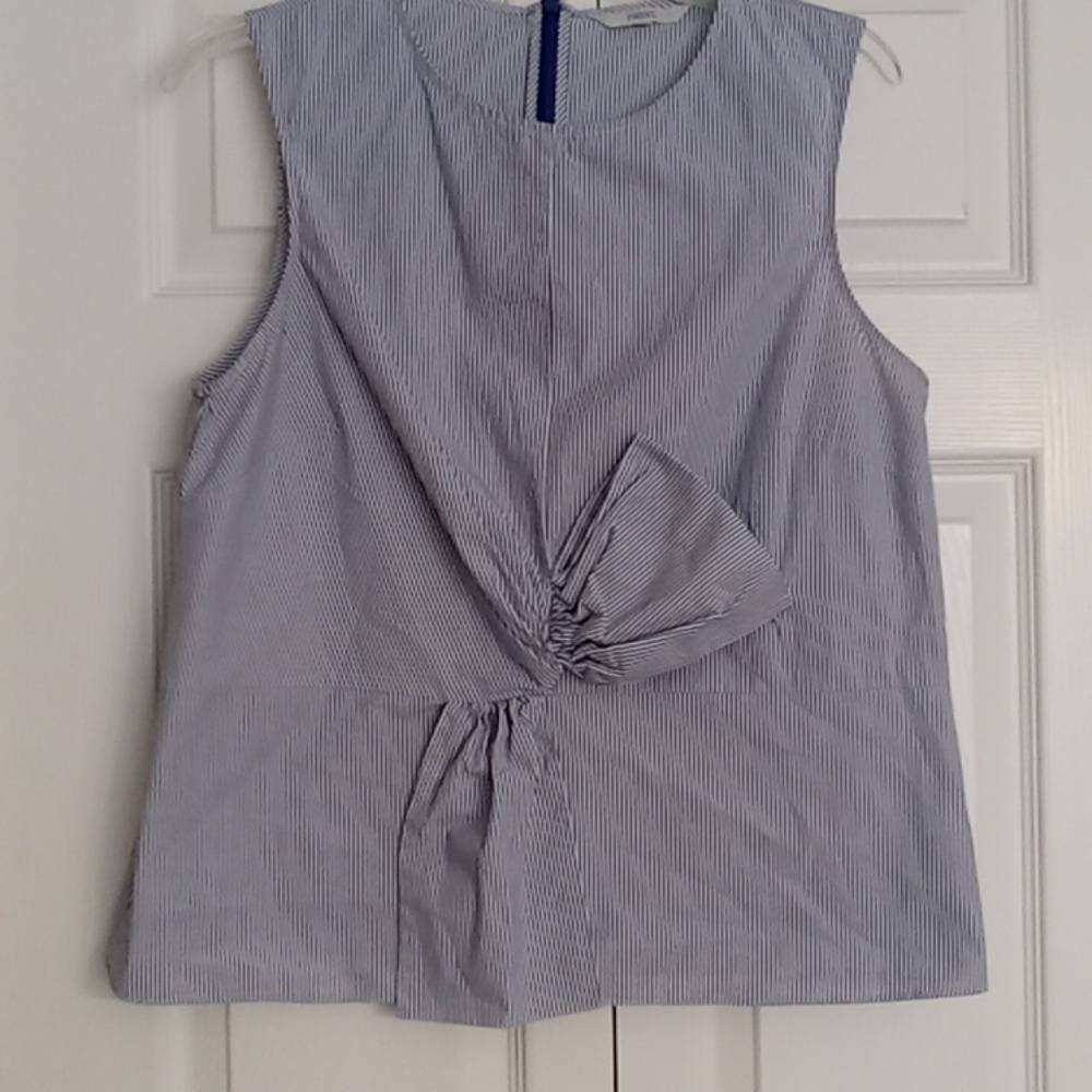 Very cute white and blue striped sleeveless top with bow in front.